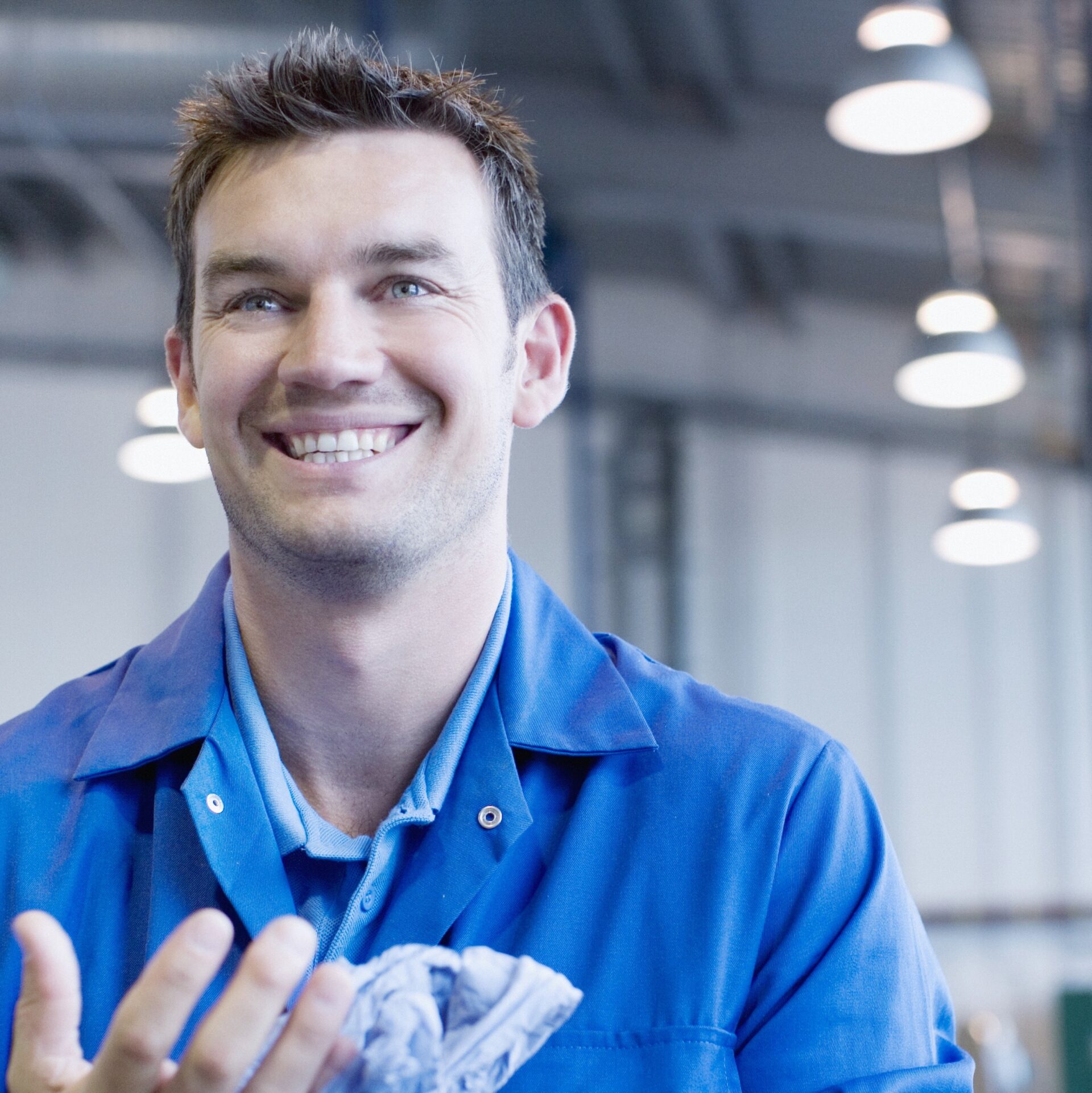 auto shop technician smiling upwards